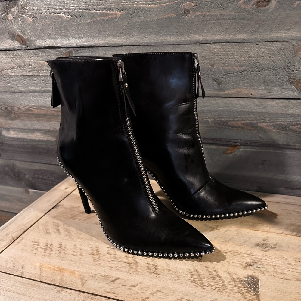 Black man made material with silver studs around boots